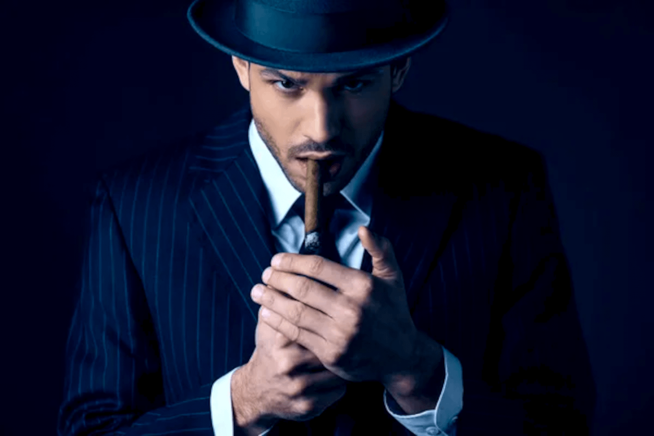 Uomo elegante italiano con cappello e sigaro, rappresenta italiani più eleganti del mondo - Pommenor